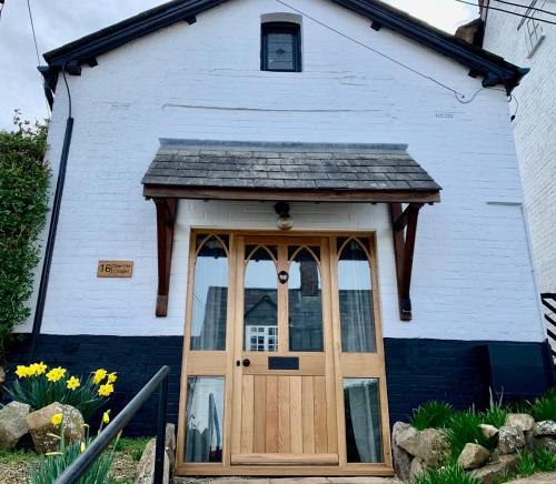 a house with a wooden door in front of it at The Old Chapel Manton in Manton