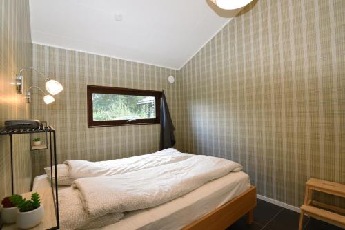 a small bedroom with a bed and a window at Nice holiday home with outdoor pool in Lottorp, Oland in Löttorp