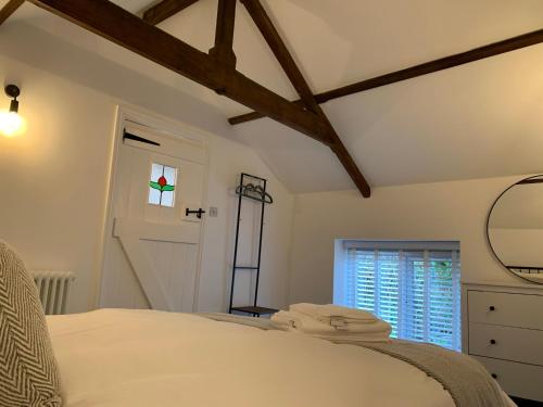 a bedroom with a white bed and a window at The Old Chapel Manton in Manton