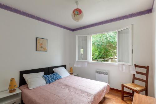 une chambre avec un lit et une fenêtre dans l'établissement Maison confortable à Vendres, 87 m², proche plage, à Vendres