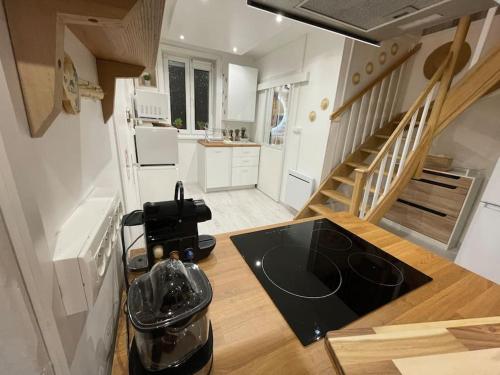 a small kitchen with a staircase in a house at Casa Inca Calais - Duplex Soleil Latino - Parking Free, Station in Calais