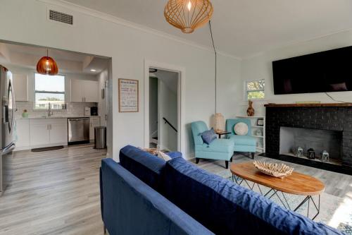 a living room with a blue couch and a table at 5 bed 4 bath pool table fire pit walk to beach in Daytona Beach