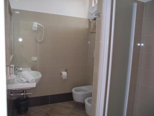 a bathroom with a toilet and a sink at Il Girasole in Terracina