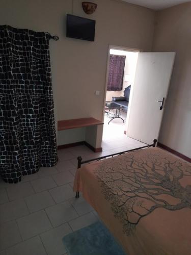 Ein Bett oder Betten in einem Zimmer der Unterkunft Auberge Le Baobab