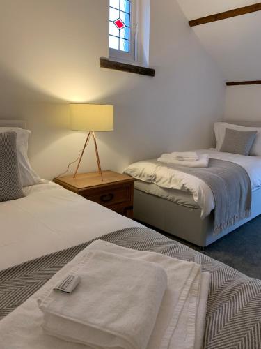 a bedroom with two beds and a window at The Old Chapel Manton in Manton
