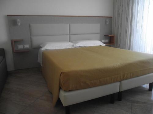 a bedroom with a large bed in a room at Il Girasole in Terracina
