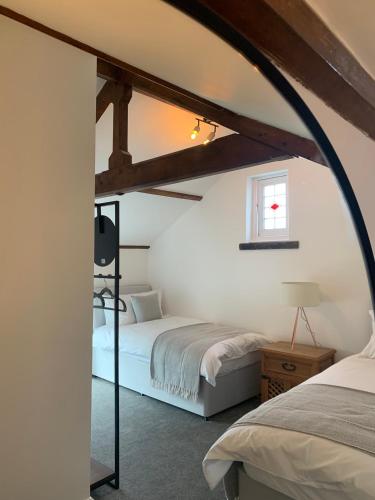 a bedroom with two beds and a window at The Old Chapel Manton in Manton
