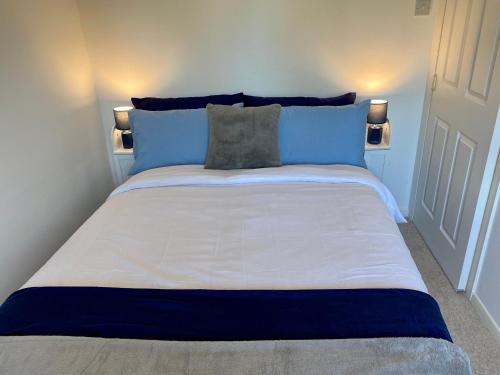 ハンスタントンにあるClose to beach. Two bed compact flat.の大型ベッド(青と白のシーツ、枕付)