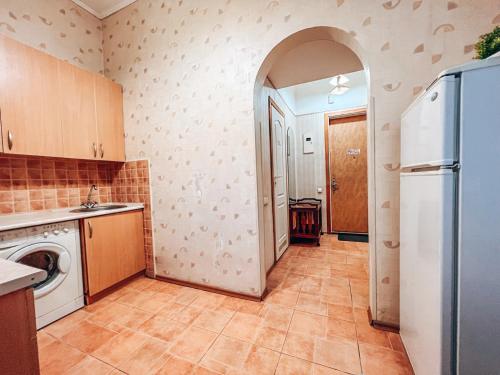 a kitchen with a refrigerator and a washer and dryer at Apartment - Independence Square in Kyiv