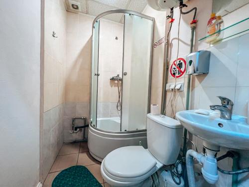 a bathroom with a shower and a toilet and a sink at Guest House near Railway Station in Kyiv