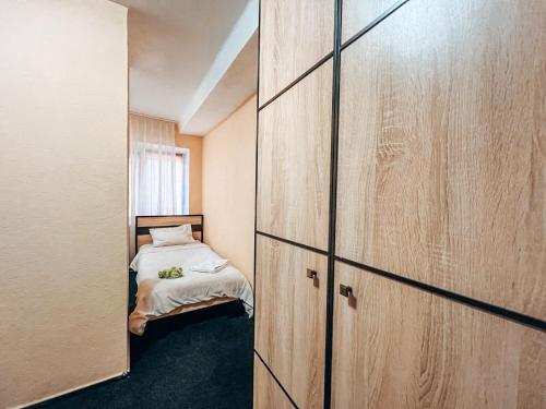 a small room with a bed and a closet at Guest House near Railway Station in Kyiv