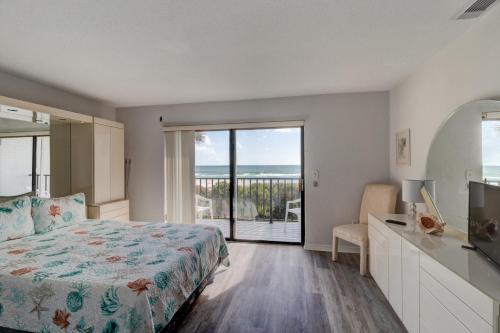a bedroom with a bed and a view of the ocean at Blue Skies Oceanfront 2 bedroom townhouse in Ponce Inlet