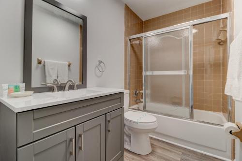 a bathroom with a sink and a toilet and a shower at Green Palms Oceanfront 2 Bed Townhouse in Ponce Inlet