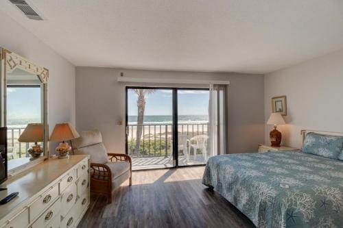 a bedroom with a bed and a view of the ocean at Green Palms Oceanfront 2 Bed Townhouse in Ponce Inlet