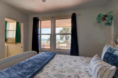 a bedroom with a bed with a view of the ocean at Beachfront 4 Bedroom 4 Bath with Huge Deck Wifi in Daytona Beach