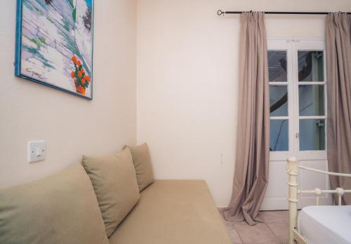 a living room with a couch and a window at Giannakas Studios in Platis Yialos Sifnos