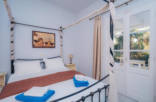 a bedroom with a bed with blue towels on it at Giannakas Studios in Platis Yialos Sifnos