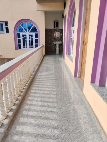 a stairway in a house with purple and white walls at PALL And SARKAR RESIDENCY in Srinagar