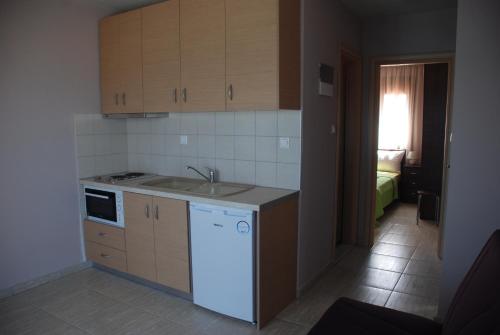 a kitchen with a sink and a counter top at Marianna Apartments in Nea Roda