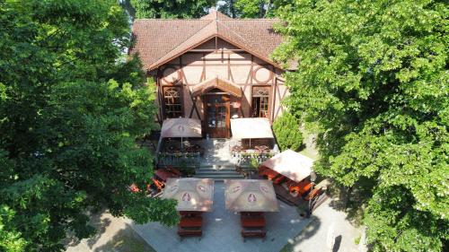 an overhead view of a building with tables and umbrellas at Penzion Restaurace Ostrov in Písek