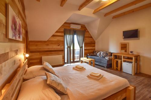 a bedroom with a bed and a living room at Villa Stone 1 in Rakovica
