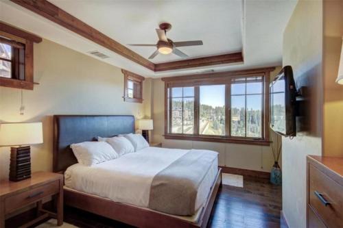 - une chambre avec un lit et un ventilateur de plafond dans l'établissement Luxury 3 Bedroom Ski In, Ski Out One Ski Hill Residence Located At The Base Of Peak 8 With Hot Tub Access, à Breckenridge