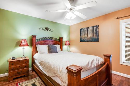 Un dormitorio con una cama y un ventilador de techo. en Jan's Riverside Retreat, en Pigeon Forge