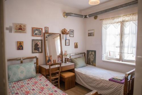 a bedroom with two beds and a mirror at Traditional House at Central Square in Zagora