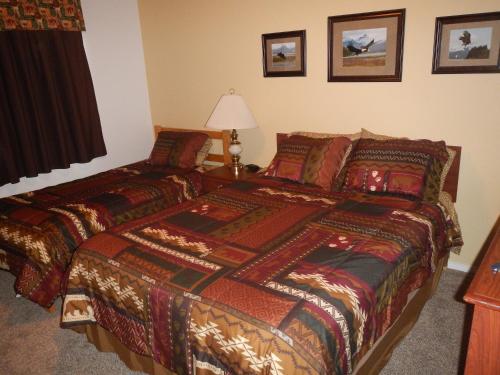 a bedroom with a bed and a table with a lamp at House on the Rock B&B in Valdez