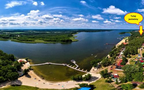 an aerial view of a lake with a sign that reads risk benefit at APARTAMENT NAD JEZIOREM in Sława