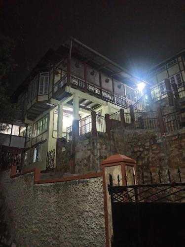 a building with a light on the side of it at night at Casa Encanto Homestay in Shillong