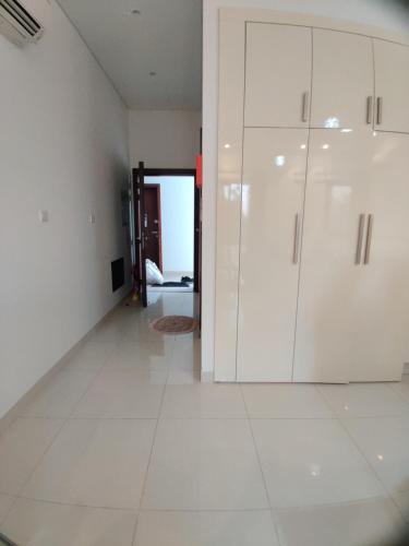 an empty room with white cabinets and a hallway at Hawana Salalah Laguna Studio in Salalah