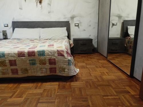 a bedroom with a bed and a wooden floor at Casa Manzoni 