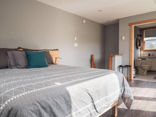 a bedroom with a bed with a gray comforter at Maple Ranch Golden in Golden