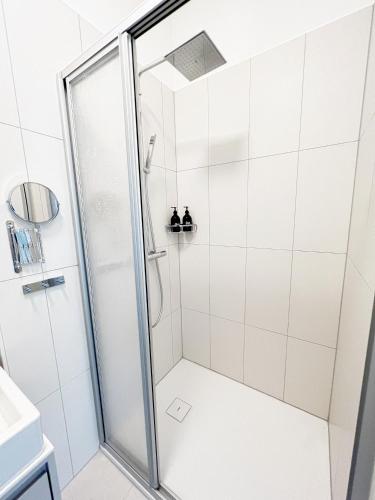 a shower with a glass door in a bathroom at Sissi West in Vienna