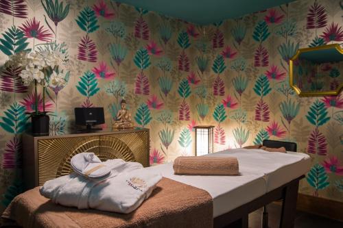 a bedroom with a bed and a floral wallpaper at Holyrood Hotel - Leisure Centre & The Spa at Orchids in Bundoran