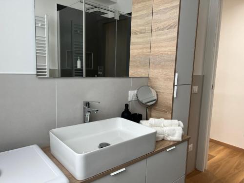 a bathroom with a white sink and a mirror at Ca' Yvonne alloggio a Lido di Venezia in Venice-Lido
