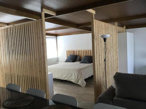 Un dormitorio con una cama, una mesa y un sofá. en Ático Pablo 5, a cinco minutos del Puerto de la Cruz, en Los Realejos