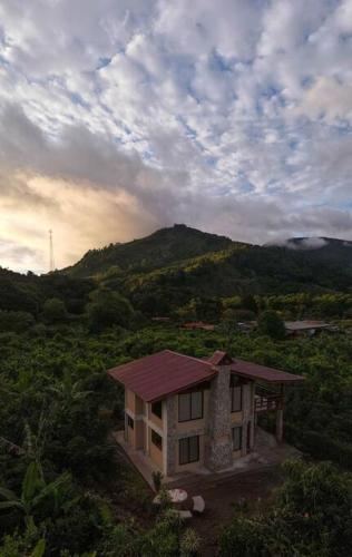 a small house in the middle of a mountain at Juliet's Coffee House in Higueronal