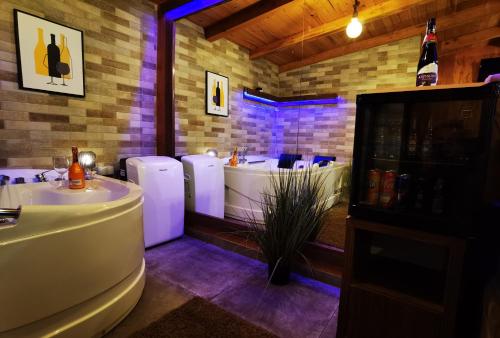 a bathroom with two sinks and a bath tub at Odmaraliste Kod Miće Apartman 3 in Krušar