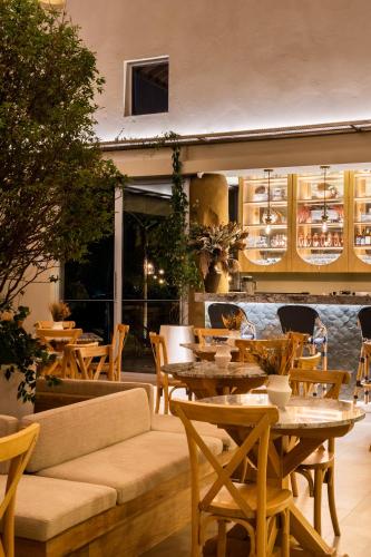 a restaurant with tables and chairs and a couch at Tau House in Guatapé