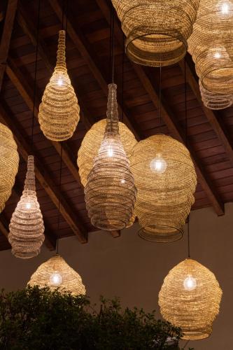 a bunch of lights hanging from a ceiling at Tau House in Guatapé