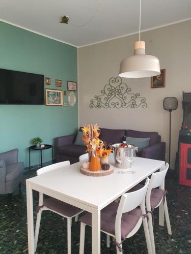 MoLo - residenza con accesso diretto al lago في لازيسي: طاولة غرفة طعام بيضاء مع كراسي وأريكة