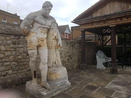 a statue of a man standing on a stump at Beautiful apartment in the heart of Rochester in Rochester
