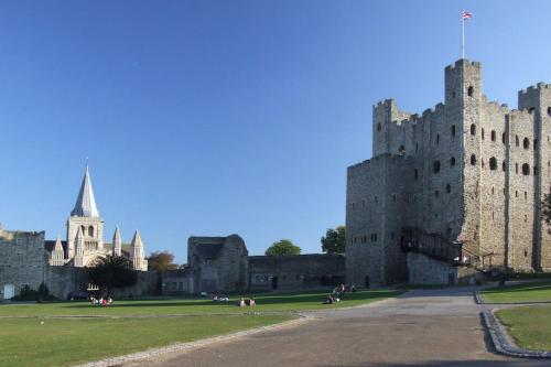 a castle in ireland with people walking around it at Beautiful apartment in the heart of Rochester in Rochester