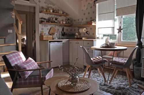 a kitchen with a table and chairs in a room at Studio Viline kose in Divčibare