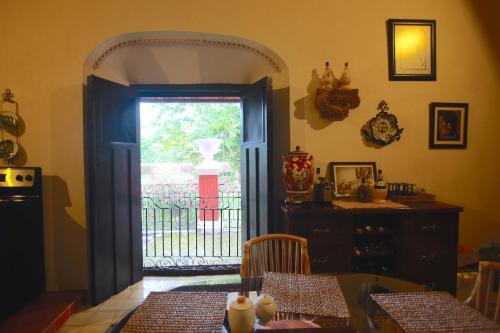 a dining room with a door leading to a gate at Hacienda San Jose Poniente in Hoctún