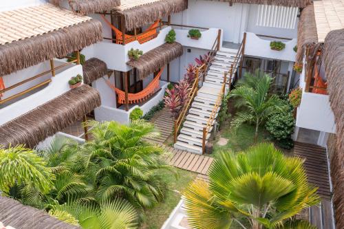 an aerial view of a building with stairs and palm trees at Pousada Chez Toi in Jericoacoara