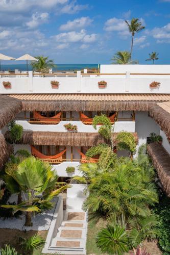 an aerial view of a resort with palm trees at Pousada Chez Toi in Jericoacoara