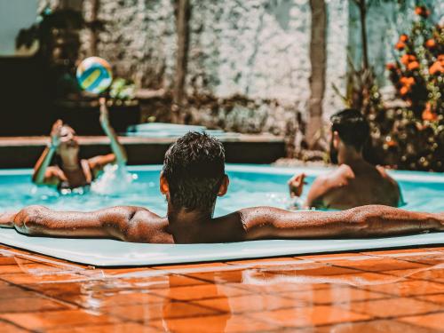 a group of people laying on a surfboard in a swimming pool at Nirvana Pipa in Pipa